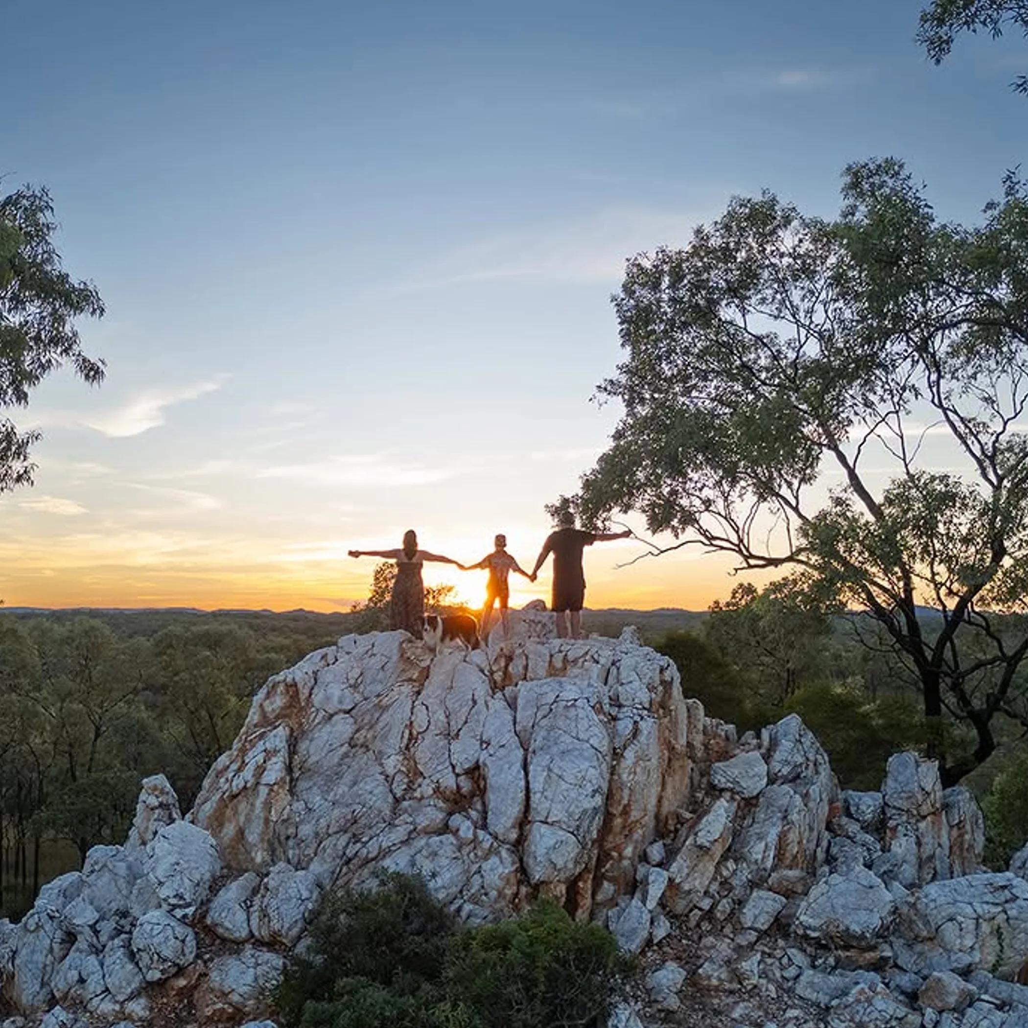 travelers atop outback rock formation